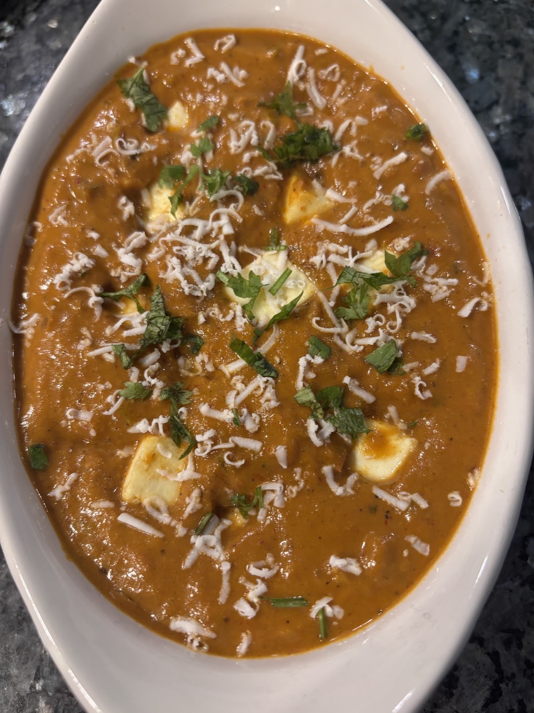 Homemade Indian curry with paneer, herbs and spices
